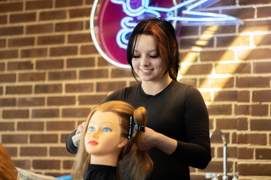 Instructor Guiding Student on Hairstyle