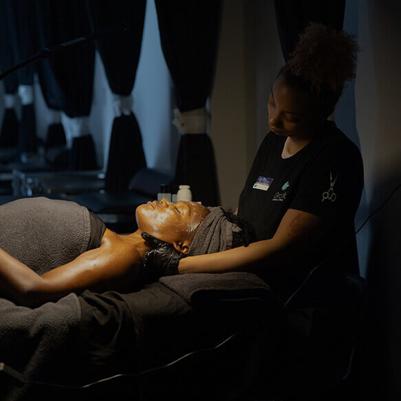 esthetician performing facial on student